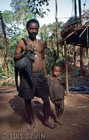Pygmy hunter with a monkey (Greater Spot-nosed Monkey, Cercopithecus nictitans)
