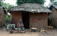 Family in front of a pygmy hut (Bedzan Pygmies)